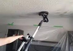 A Calgary popcorn ceiling being removed with a machine, the machine looks like the head of a carper clerner, its circular shape 