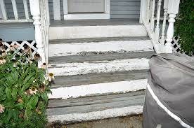 An old proch and steps, the white coloir paint is npeeling. it really needs painting